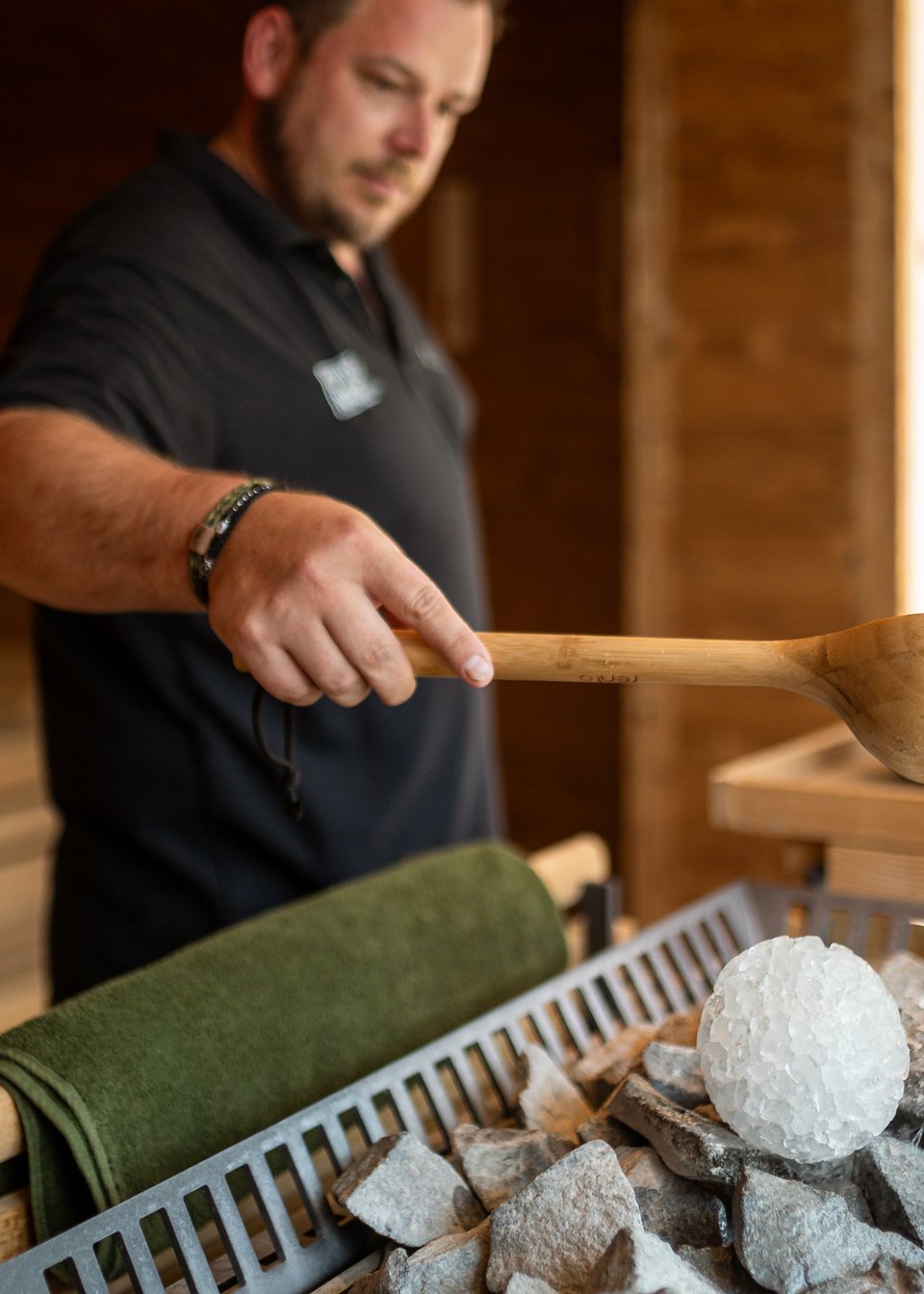 The sauna master stands in the sauna and makes an infusion The sauna master stands in the sauna and makes an infusion