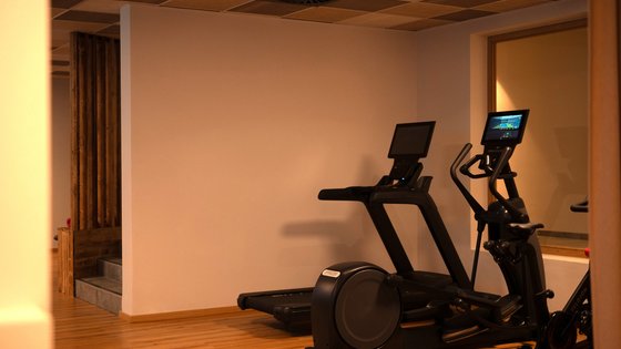 Fieberbrunn: wellness hotel wanted? Gym room with treadmill and elliptical trainer on wooden floor