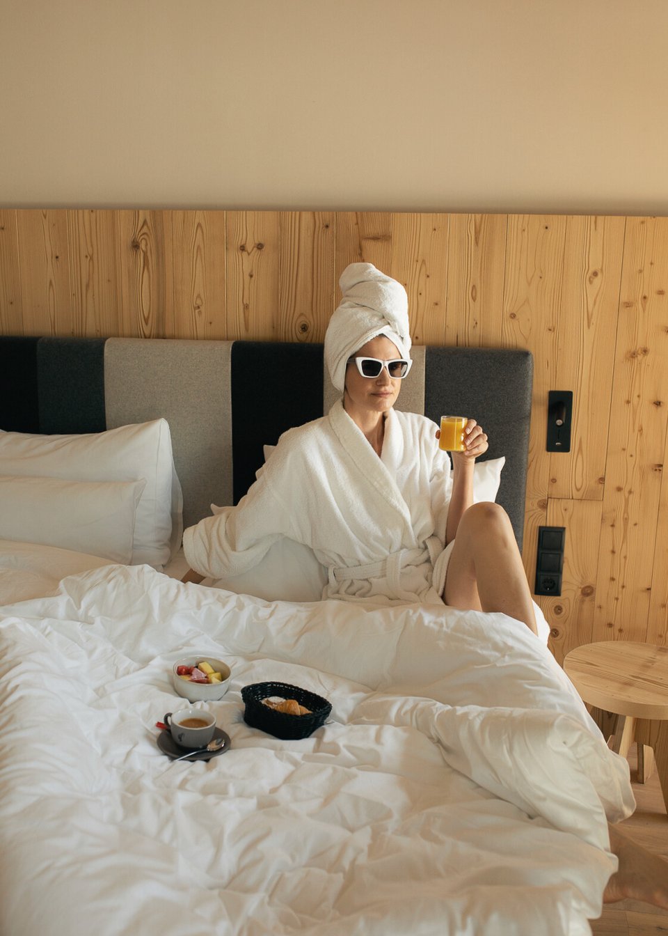 Woman enjoying her rich breakfast in bed Woman enjoying her rich breakfast in bed