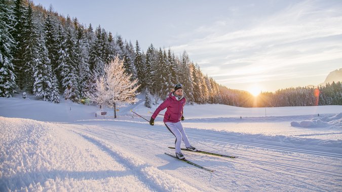 Woman cross-country skiing in the Pillerseetal valley Woman cross-country skiing in the Pillerseetal valley