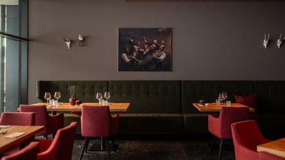 Modern restaurant with set tables and red chairs in Fieberbrunn Modern restaurant with set tables and red chairs in Fieberbrunn